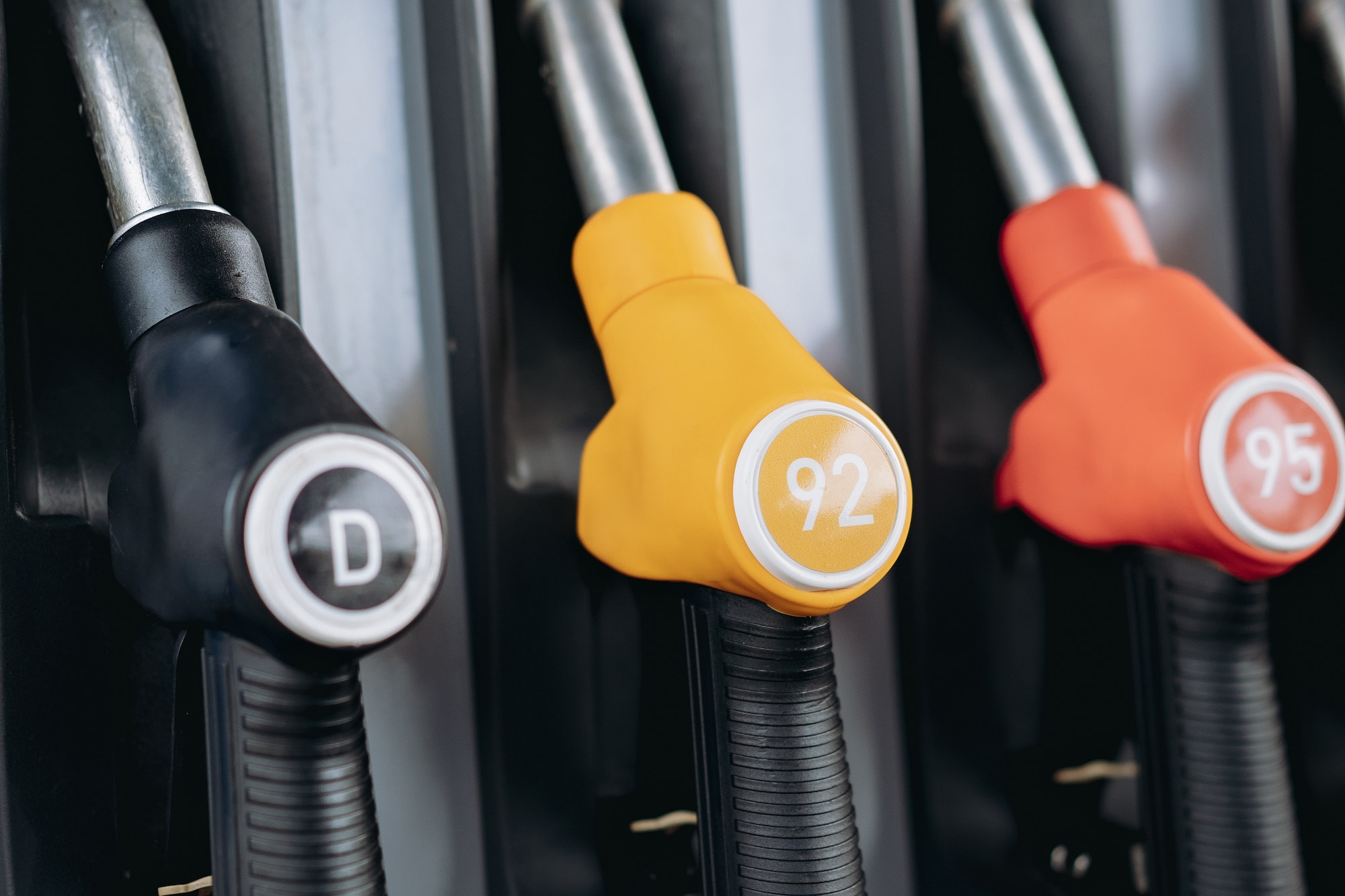 petrol pump filling fuel nozzles at gas station