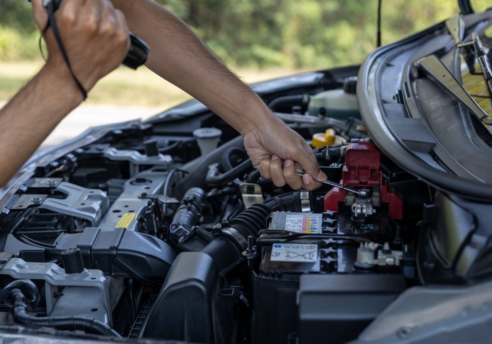 Man is Checking car battery because car battery is depleted. concept car maintenance